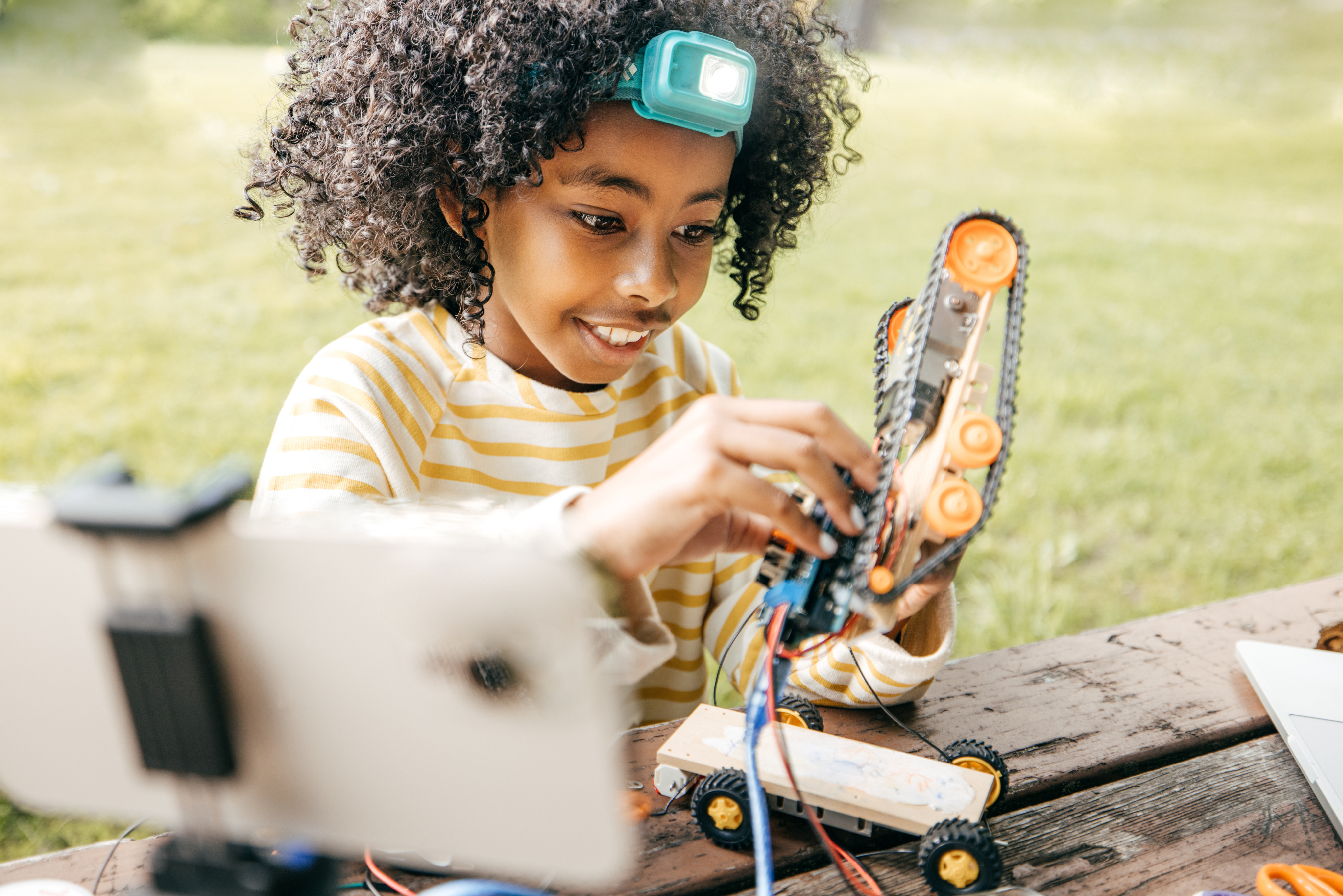 Youth at camp tinkering with robot